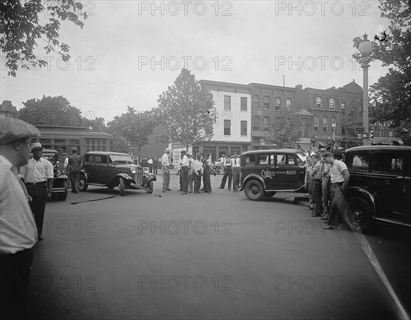 Street scene, people milling around after an auto accident ca. between 1910 and 1935