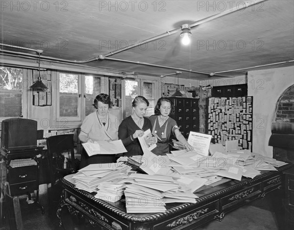 Workers going through envelopes for the Women's Party, Equal Rights essay contest ca. early 20th century