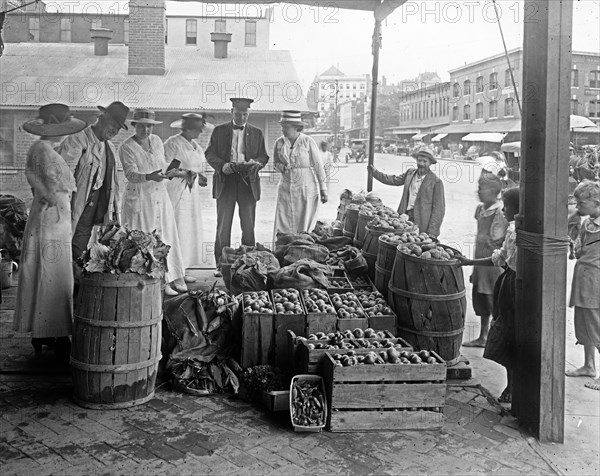 Customers at a food market, Washington D.C., World War I period. ca.  between 1910 and 1920