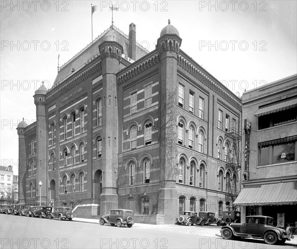 Cars parked on the street outside of Franklin School Building exterior, 13th St., N.W., Washington, D.C. ca. between 1910 and 1935