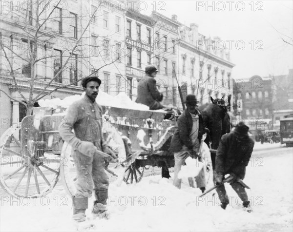 Men loading snow onto a wagon, after snow storm, in Washington, D.C. ca. [between 1909 and 1920]