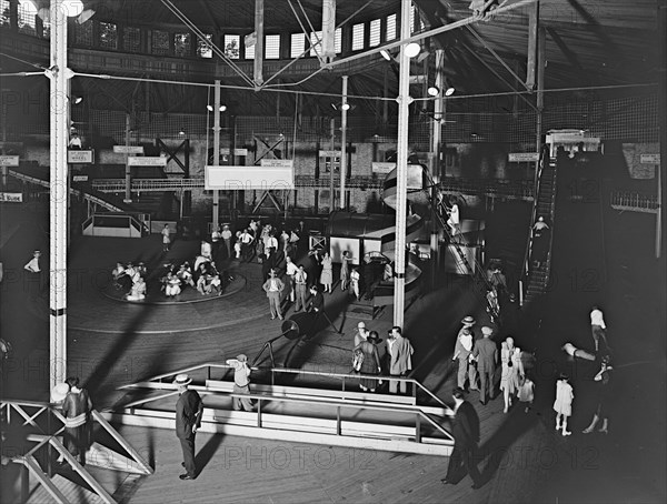 People enjoying a fund day at an emusement park (fun house and spinning wheel) in Glen Echo, Md. ca.  between 1910 and 1935 (probably 1928)