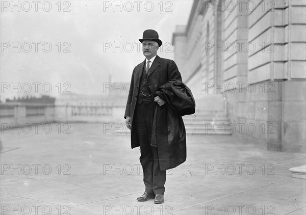 Ex-Gov. Judson Harmon of Ohio holding a top coat ca. between 1909 and 1919
