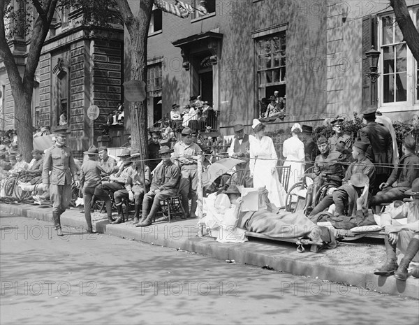 Men, women and children watching the Pershing parade ca. between 1909 and 1923