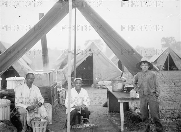 U.S. Army cook tent, men peeling potatoes ca. between 1909 and 1940