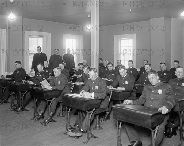 Cadets studying in a classroom at Police School ca. between 1909 and 1940