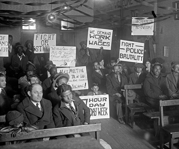 Communist Protesters in early 20th century, Communist Young Party Communist League meeting holding up protest signs like Fight or Starve and 7 Hour Work Week ca. 1925