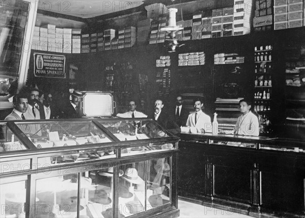 W&R Store of a British importer, workers standing behind a display of hats ca. between 1909 and 1919