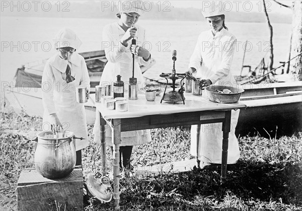 Girl Scouts canning fish ca. between 1909 and 1920