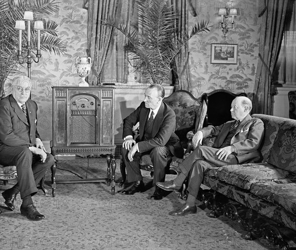 Group of men listening to a radio ca. between 1909 and 1923