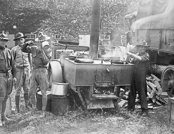 Soldiers cooking food at a army field kitchen, 1st Division boys ca. between 1909 and 1932