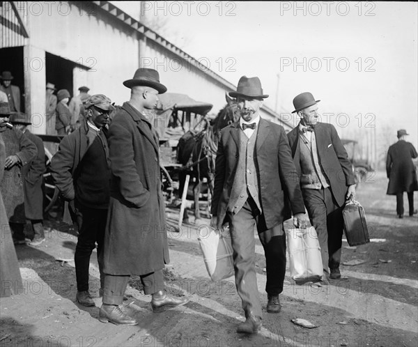 Men carrying packages of whiskey ca.  between 1918 and 1920
