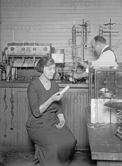 Man and woman in laboratory performing duties to obtain sugar from corn ca.  between 1918 and 1921