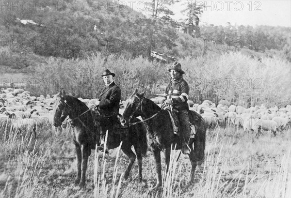 Edd Ladd, full-blood Apache Indian, of the Jicarilla Reservation, New Mexico, with Indian Commissioner Cato Sells, on horseback ca. 1909