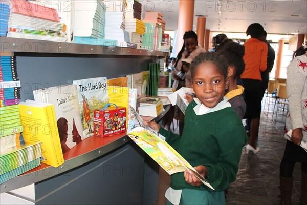 A Namibian school girl looking through a school textbook in a Namibia school ca. 20 July 2017