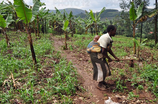 20 year old Prossy farms at her home with 17 month old daughter, Promise in Uganda countryside ca. 13 March 2018