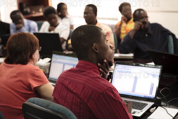 West African men and women gaining professional skills in accounting class ca. 28 July 2010