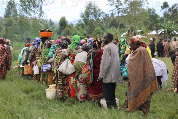 Rural residents stand in a line while they wait for help from relief workers during a crisis in North Kivu Cote d’Ivoire (Ivory Coast) ca. 22 March 2017