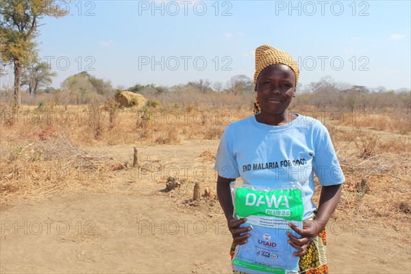 A woman receives a mosuqito net in Mbire Zimbabwe  ca. 31 August 2016