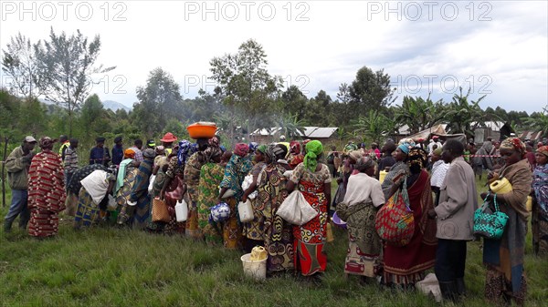 Women in colorful traditional dress wait for relief help during a crisis in North Kivu Cote d’Ivoire (Ivory Coast) ca. 22 March 2017