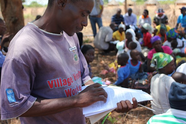 Village Health Worker Checks Health Records, Zimbabwe   ca. 30 November 2016