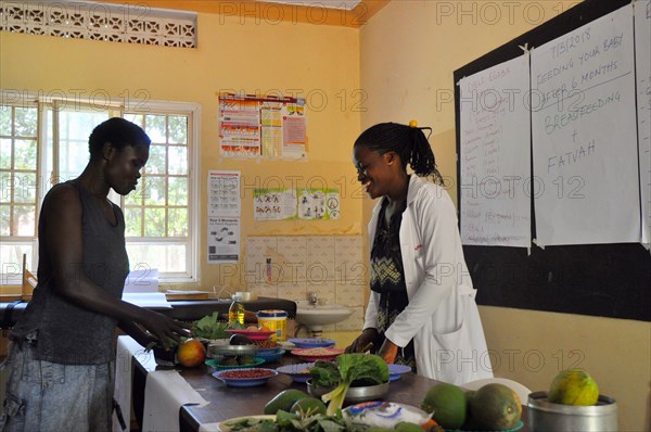 One caregiver moves foods into categories based on how they impact their child's growth and development during an interactive portion of a cooking demonstration ca. 7 March 2018