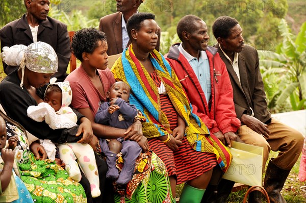 Karrowa Village members listen during a community group meeting discussion on key nutrition and WASH behaviors (Uganda) ca. 13 March 2018