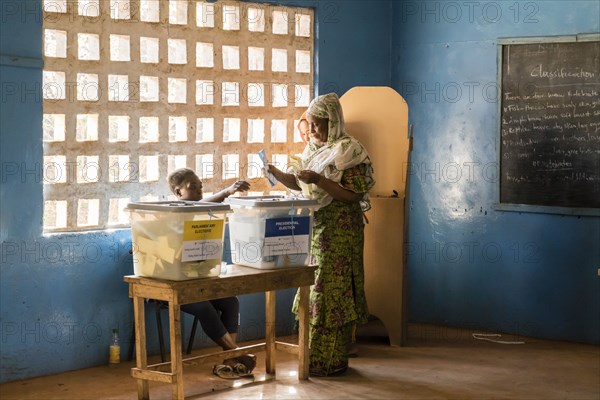A woman in Sierra Leone casts her ballot in the Sierra Leone presidential election ca. 7 March 2018