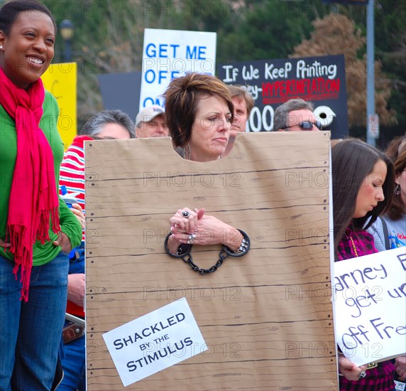 Attendees holding signs at a Tea Party rally in Dallas, TX (one of the first in the United States on Feb. 26 2009)