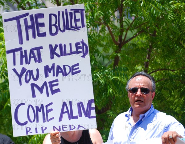 Iranians in Texas taking part in a Freedom for Iran / Green Revolution rally at Dallas City Hall plaza in downtown Dallas, TX; protest signs ca. June 2009