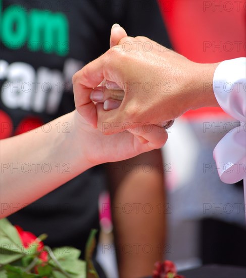 Iranians in Texas taking part in a Freedom for Iran / Green Revolution rally, two protestors hold hands, at Dallas City Hall plaza in downtown Dallas, TX ca. June 2009