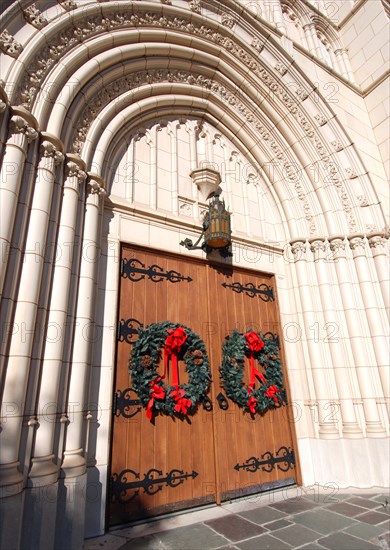 Large church building in downtown Ft. Worth with front doors decorated with Christmas wreaths for the season