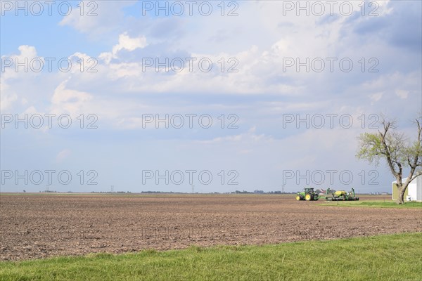 John Deere tractor in a field with no crops in eastern Illinois