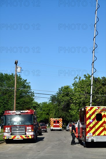 First responders; firemen and paramedics, help trapped construction worker trapped in a trench; ambulance hurries the rescued worker to the hospital Irving, TX USA