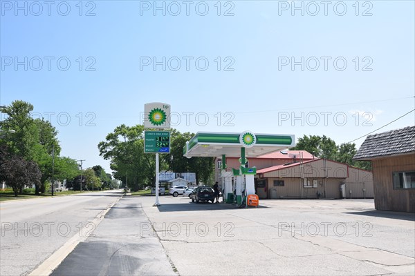 Customers pumping gas at the BP gas station in Cissna Park, Illinois