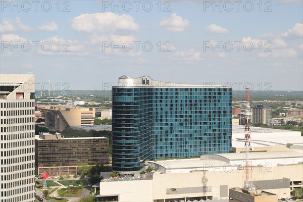 Aerial view of downtown Dallas with the Omni Hotel in the center and Dallas City Hall in the background