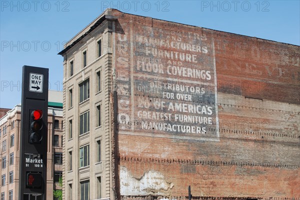 Red traffic light in downtown Dallas on Market Street, old advertisment on an office building ca. 2010