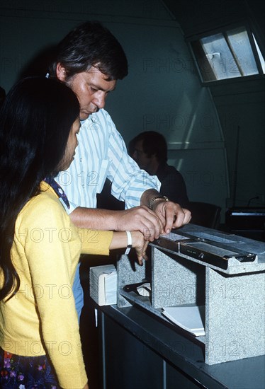 A Vietnamese refugee is fingerprinted