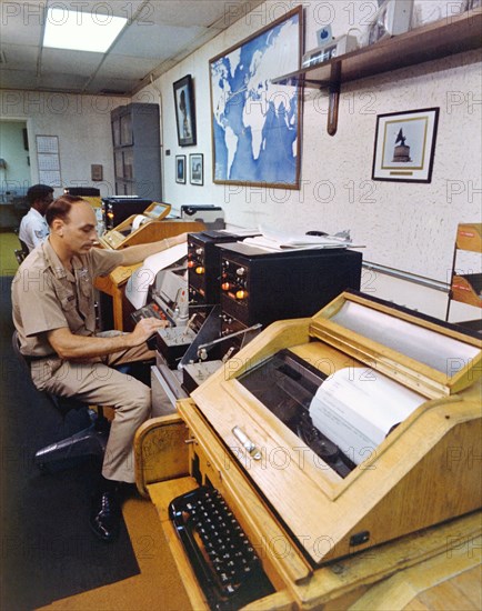 Soldier and an airman sit at their operations positions