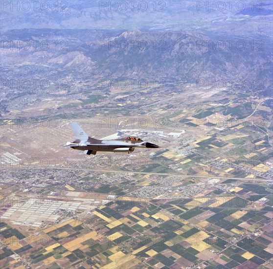 An air-to-air right front view of an F-16 Fighting Falcon aircraft