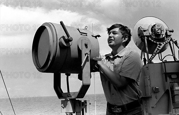 A signalman aboard the guided missile destroyer USS DEWEY