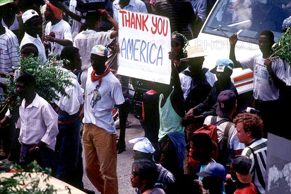 Haitians hold up a 'Thank You America'