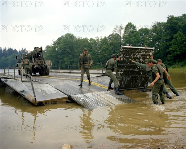 A ribbon bridge is assembled