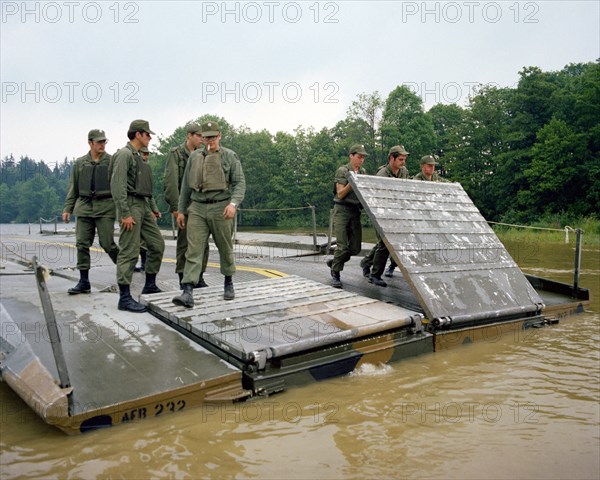 A ribbon bridge is assembled by members of the 1457th Engineering Battalion