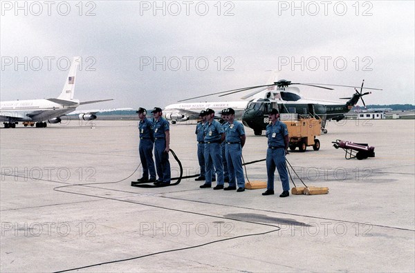 An aircraft maintenance crew stands by as President Jimmy Carter returns from his European visit.