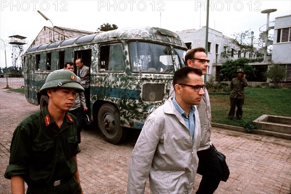 Prisoners of war disembark a bus