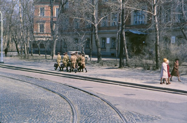 A group of Soviet soldiers carrying satchels and briefcases