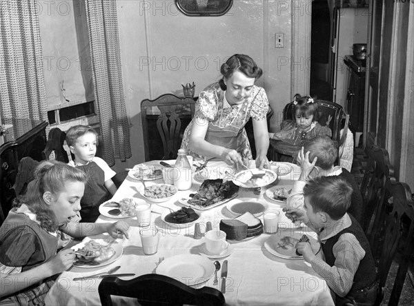 Mother serving family meal