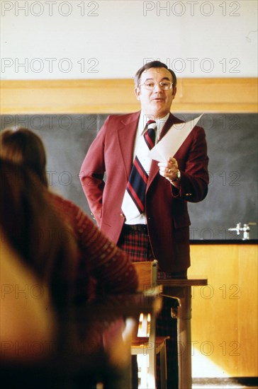 A Teacher Talks to His Students in a Classroom