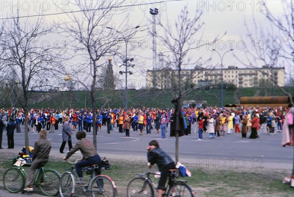 Bicyclists watching a parade of people in Moscow ca. May 1978